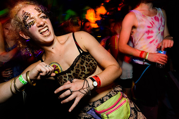 Girl dances at TRibe of Frog's 13th birthday party in a UV atmosphere.