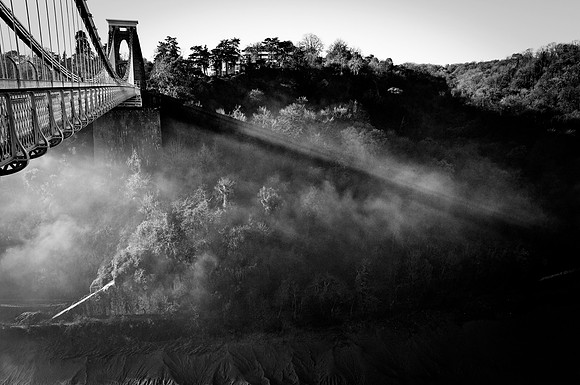black and white image of Clifton Suspension bridge whilst surrounded by fog